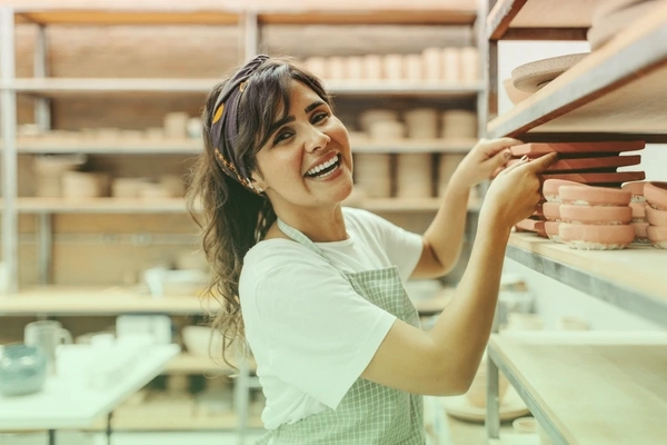 Artisan workspace with handmade crafts and business planning materials