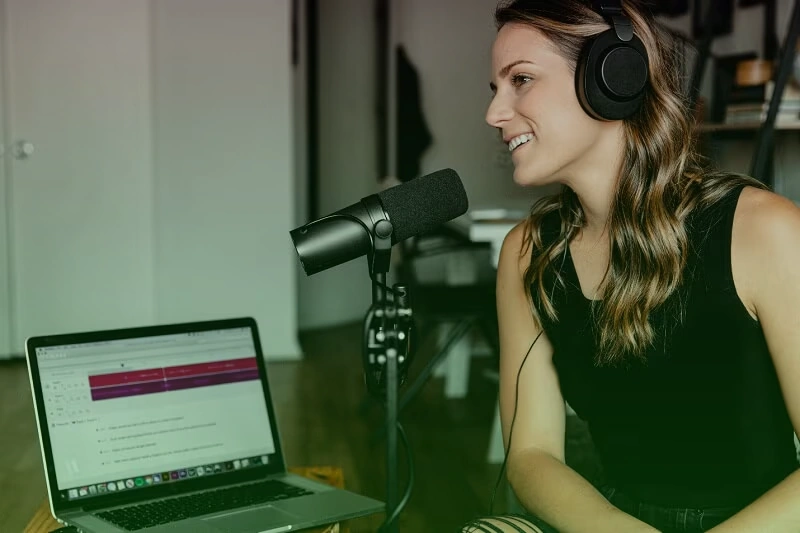 Professional podcast recording studio with microphone and naming strategy materials