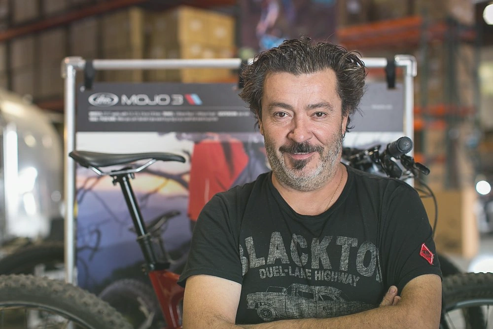 Professional bike shop owner discussing business naming strategies with cycling industry experts